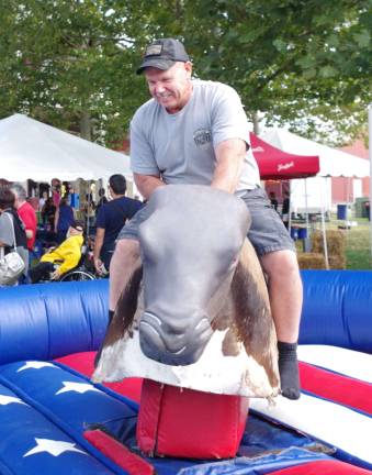 Steve Gumann of Freehold is shown during one of his attempts to ride the hornless bull with a very slippery saddle.