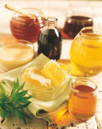 Photo courtesy National Honey Month Several varieties of liquid honey, comb honey and creamed (whipped) honey.