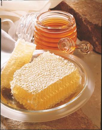 Photo courtesy National Honey Board A display of liquid honey alongside a block of comb honey.