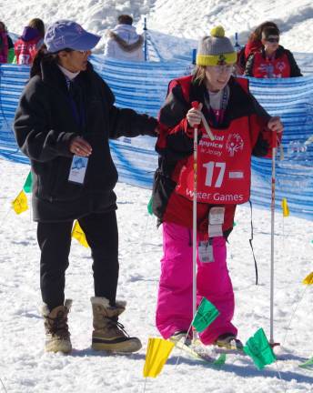 An official offers suggestions as she coaches Teresa Kelly of Franklin to the starting gate.