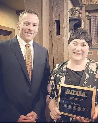 Board member Brian Drelick stands next to STEM teacher Holly Romahn.