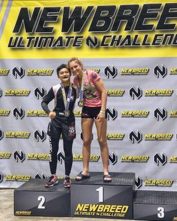 Brooke Fahey atop the podium after winning a gold medal in No-Gi competition.