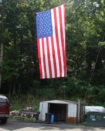 This giant, probably 100-foot, American flag hangs in the parking lot of Firehouse Bagel Company in Franklin.