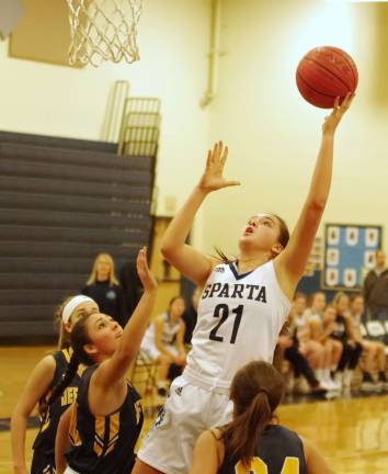 Sparta's Emily Dilger takes the ball high towards the hoop during a shot. Dilger scored 12 points.