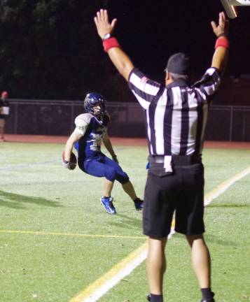 After catching the ball in the end zone Sussex Stags wide receiver Nick Bochna looks at the official who gives the touchdown signal.