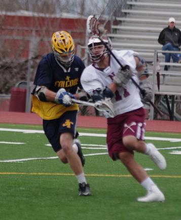 The ball is carried by Newton's Ryan Qasem as Jefferson's Peyton Faasse keeps pace.