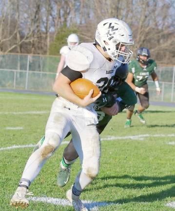 Wallkill Valley ball carrier Ben Mizeski is grabbed by a Hopatcong defender in the second half. Mizeski rushed for 244 yards and scored three touchdowns.