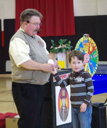 Firefighter Phil, portrayed by ventriloquist Dave Carr talks about checking smoke alarms once each month and replacing the batteries twice each year. Here, an enthusiastic student helps teach the lesson.