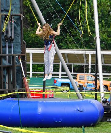 Young people enjoy the Sling Shot and Rock Climbing Wall