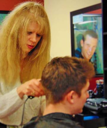 Veteran hairdresser opens salon Photos by Claudia Caramiello Hairdresser Kim Williams with a client.