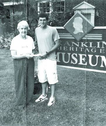 Kodie Hilbert of Wallkill Valley Regional High School is presented with a scholarship by Betty Allen, trustee of the Franklin Historical Society.
