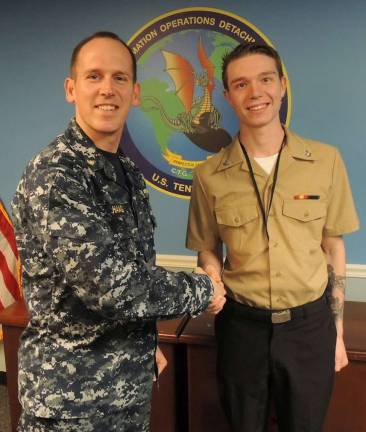Petty Officer David Vanarsdale receives his promotion from Navy Information Operations Detachment Groton&#xfe;&#xc4;&#xf4;s officer in charge Lt. Cmdr. Ryan Haag.