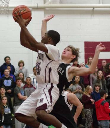 Newton's John McDaniel glides towards the hoop with Wallkill Valley's Dylan Harlos glued to his back.