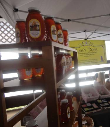 Sussex County celebrates fall with Harvest, Honey and Garlic Fest at Fairgrounds Lee's Bees, of Hardyston, displaying local honey and products.