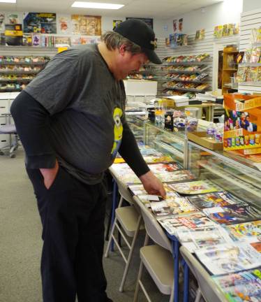 Children’s Reading Awareness Month includes free comic books Vernon firefighter Guy Kovalcik looks through the free comics at Bob's Collectables. He also made some purchases during his visit.