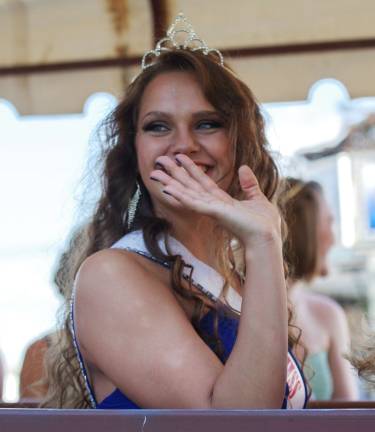 Miss Sussex Borough Camryn Krynicky waves to onlookers during a ride.