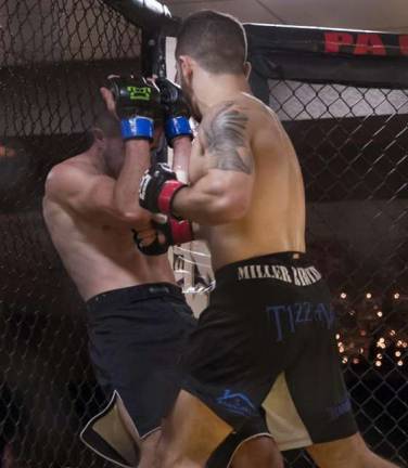 Local gym wins three championship fights Joe Tizzano lands a powerful body blow in his victory over Tyler Feist