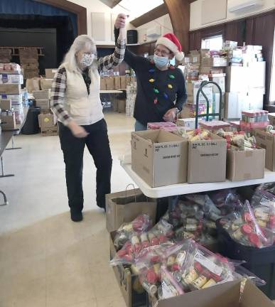 Volunteers Richard and Pat celebrate another successful packing year