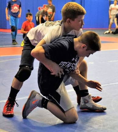 Daniel Wask, above, practices new wrestling moves.