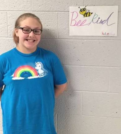 Ogdensburg student Charlotte Gough stands by the poster she made to remind everyone to be kind.