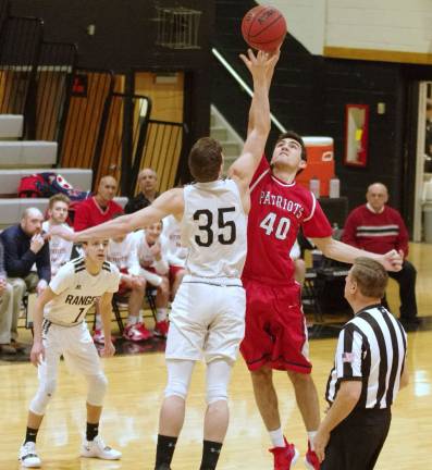 Wallkill Valley Ranger Shane Geene and Lenape Valley Patriot Bobby Winegar reach for the ball during the tip-off to start the game.