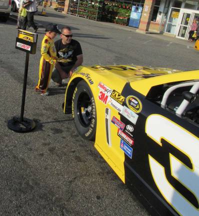 Mason and his father admire the race car at the Byram ShopRite.