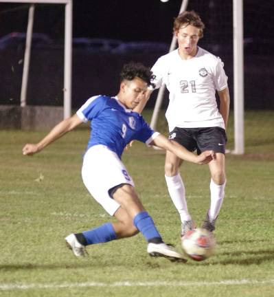 Kittatinny's Gian Knippenburg kicks the ball while shadowed by Wallkill Valley's A.J. Rosario in the first period.