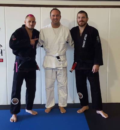 Officer Sean Licata (center) receives his second stripe from Professors Sean Santella (left) and Jim Miller (right).