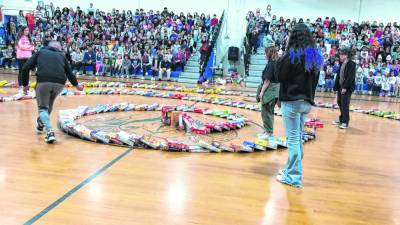 The entire Franklin Borough School student body watches the 432 cereal boxes collected in the past month fall down Thursday, Feb. 29. They were to be donated to local food pantries. (Photo by Kathy Shwiff)