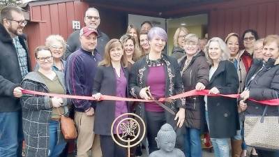 Photographed in center is Garden of Life Massage owner &amp; Licensed Massage Therapist, Dawn Gomez cutting the grand opening ribbon surrounded by staff, family, &amp; friends of Garden of Life.