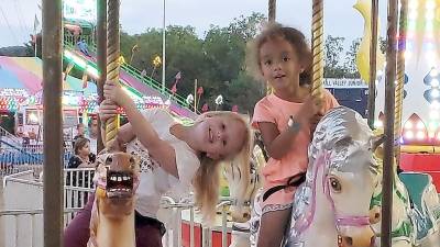 Lily and Dakota enjoyed riding the merry-go-round together