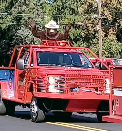 Smokey the Bear from the NJ Forest Fire Service waived to the crowds lining the street of Franklin.