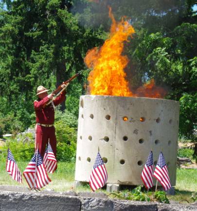 Wallkill Valley VFW Memorial Post 8441 of the Veterans of Foreign Wars Commander Jim Davis fires three ceremonial rounds as the fire engulfs more than 50 cubic feet of retired flags.