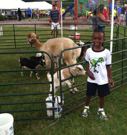Photos by Laura J. Marchese Maddoxx Boyd is shown having fun with the animals at Hardyston Day.