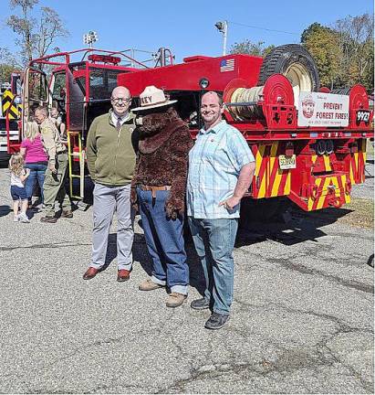 Library Director Will Porter and Youth Services Coordinator Leigh Wilkinson visit with Smokey Bear during the Main Library’s 10th Annual Touch-A-Truck event.