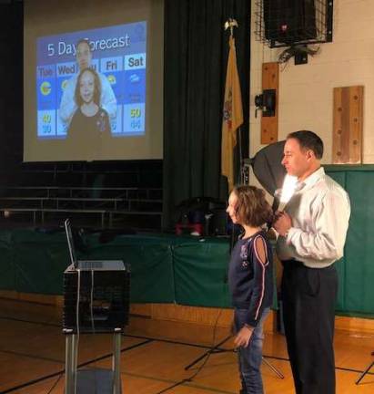 Weatherman visits Ogdensburg school John Marshall and an Ogdensburg student do the weather.