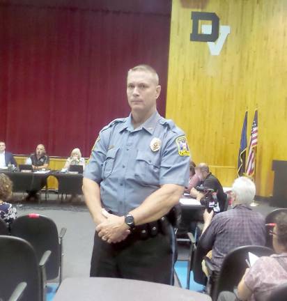 Two police officers stood sentinel over the fractious meeting (Photo by Frances Ruth Harris)