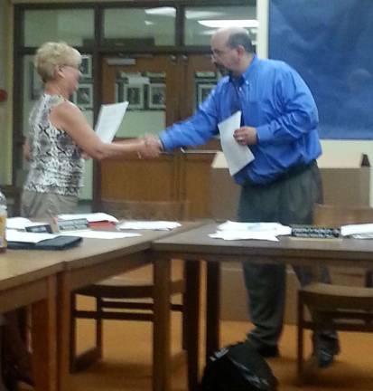 Photo by Lori Comstock Ginny Jones, left, is sworn in as the newest member of the Wallkill Valley Regional High School Board of Education on Wednesday, June 25.