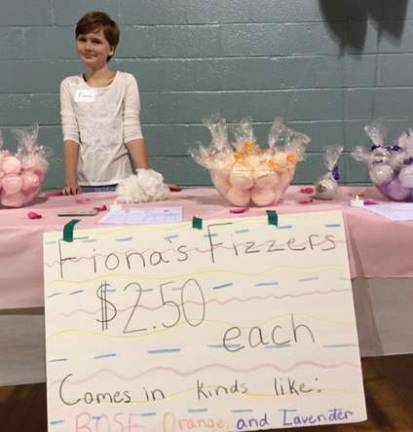 Sixth-grade student Fiona Cummings sells her homemade bath bombs.