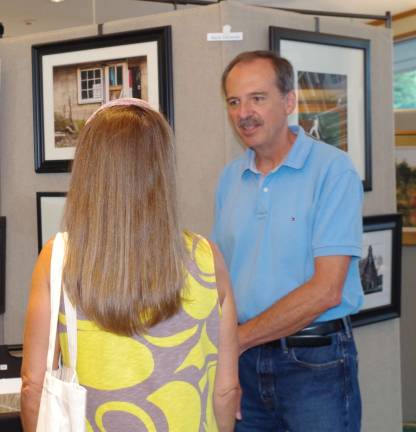Photographer Rich Swenson speaks to an attendee of the Highland Lakes Professional Artists&#xfe;&#xc4;&#xf4; Show.