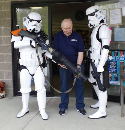 Children’s Reading Awareness Month includes free comic books From the left, Stormtrooper TK-27200 (Andrew Della Iacono of Oakland), Bob's Collectables storeowner Bob Adams, and Stormtrooper TK-41066 (Chris Manning of Vernon) stand in front of the store. Both stormtroopers are members of Northeast Remnant, 501st Legion.