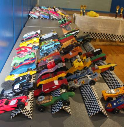 Hand-carved cars ready to race.