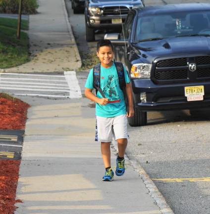 A student walks to the first day of school.