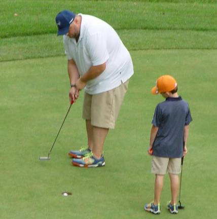 Dad sinks putt as son Jaden Savage looks on to capture 2nd place in the K-4 Division