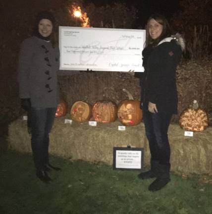 Wallkill Valley wins contest Art Teacher Amy Fairweather receiving the check from Lorien Galan of Crystal Springs Resort.
