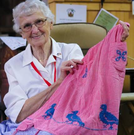 Nan Horsfield, of Layton, proudly shows her favorite apron made by her grandmother who was born in 1897.