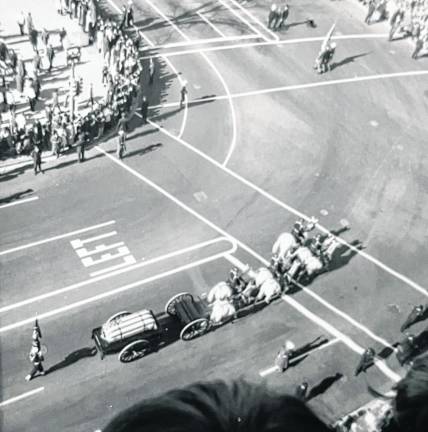 TR2 Photo of President Kennedy’s flag-covered coffin on a caisson pulled by horses.