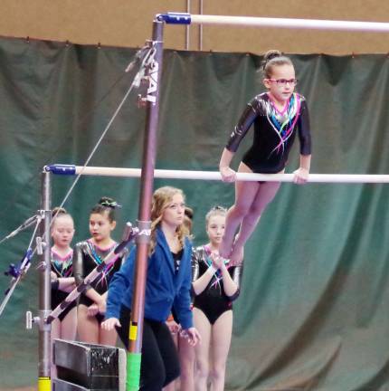 Westy's gymnasts Hanna Garafano (9) practices on the uneven parallel bars.