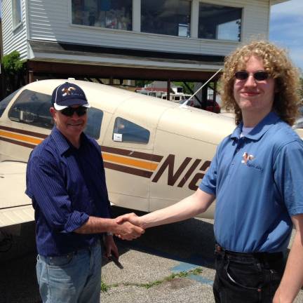High Point senior completes solo flight Christian Tracy, right, recently completed his first solo flight. Instructor and Eagles Arie owner Arie Fussman.