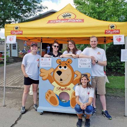 Maggie Dougherty (Hackettstown), Kelsey Denison-Vesel (Landing), Catie Coffaro (Hamburg), Alex Douglas (Mt. Arlington), and Kayla Steele (Dingmans Ferry, PA) encourage fairgoers to &#x201c;Feed Scrunchy&#x201d; as a fun way to kick-off the ShopRite Partners in Caring Campaign, which provides food, goods, and funds to local food banks.